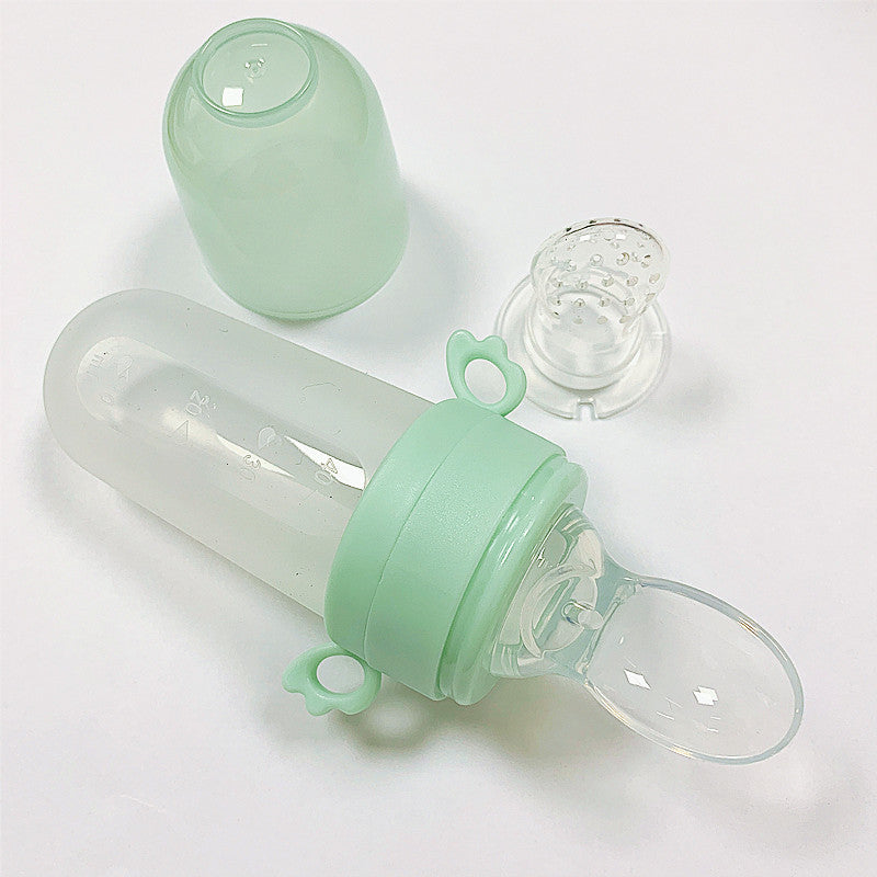 Mint green baby bottle with clear components on a white background