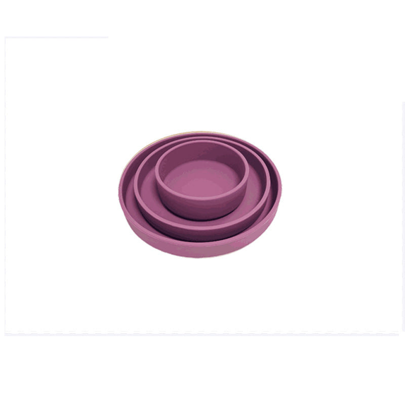 Set of purple silicone bowls on a white background