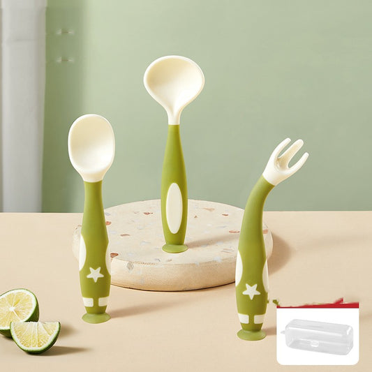 Set of green baby utensils including spoons and a fork on a neutral background.