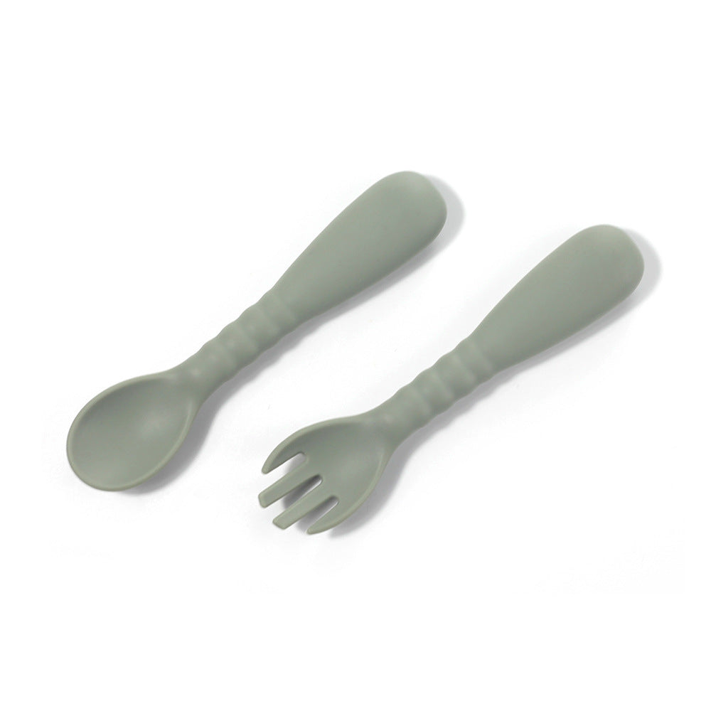 Set of green spoon and fork on a white background