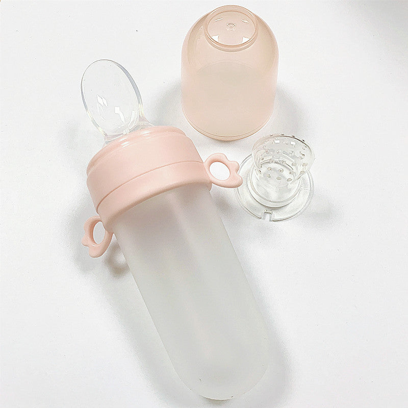 Pink baby bottle with a clear lid on a white background