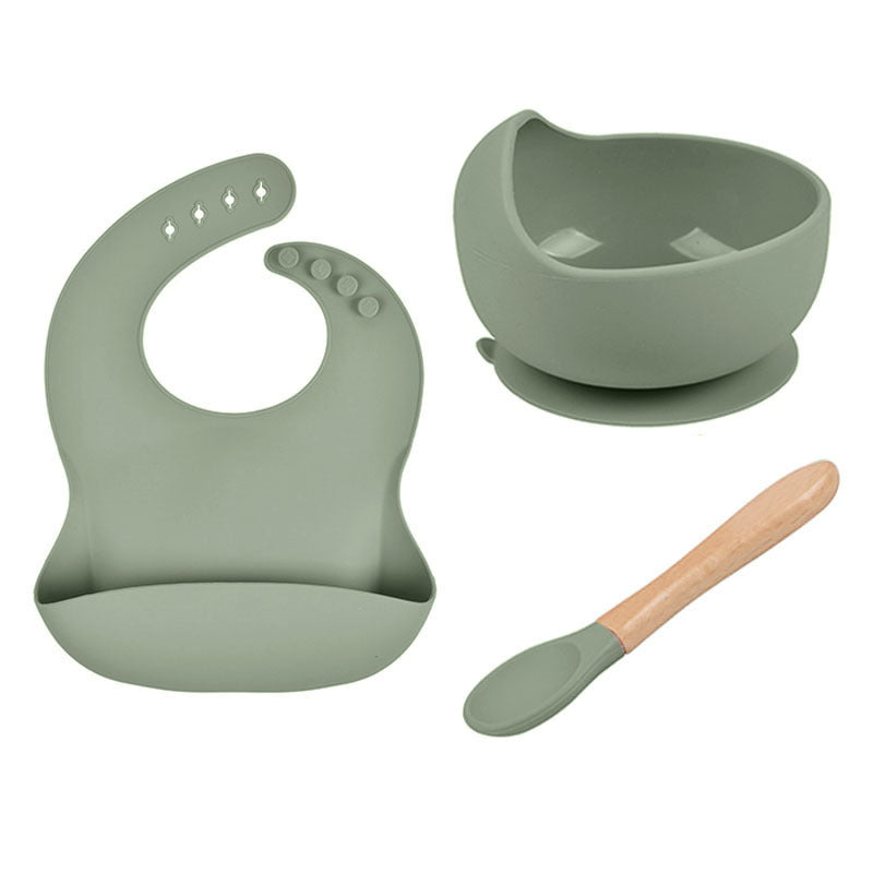 Sage green baby bib, bowl, and spoon set on a white background